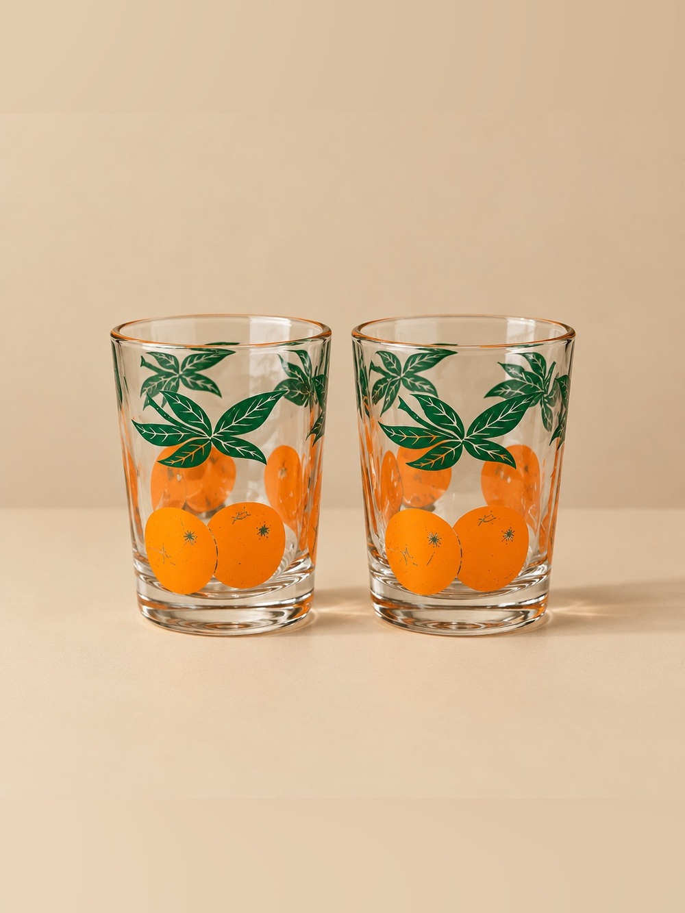 Anchor Hocking Set of 2 orange and green leaf juice glasses from the 1970s.